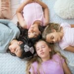 Four young girls peacefully sleeping during a fun sleepover.